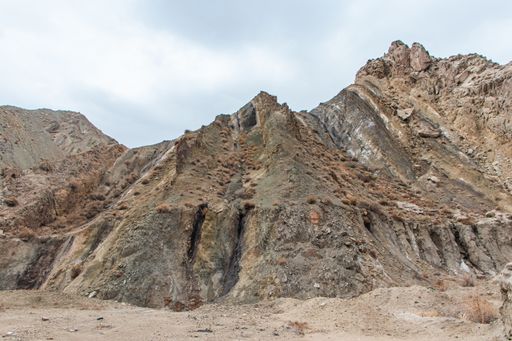 A low angle shot of a rocky cliff in the rural area of Western China