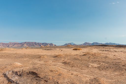 A desert with mountains background on a sunny day in the west of China