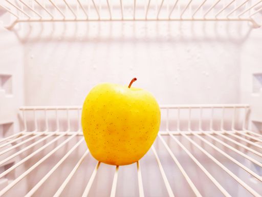 The close-up of apple inside the empty fridge