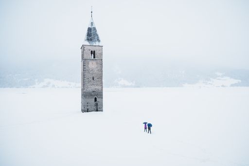 A beautiful shot of the tower in the middle of the Lake Reschen during winter in South Tyrol, Italy