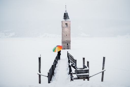 A beautiful shot of the tower in the middle of the Lake Reschen during winter in South Tyrol, Italy