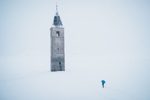 A beautiful shot of the tower in the middle of the Lake Reschen during winter in South Tyrol, Italy