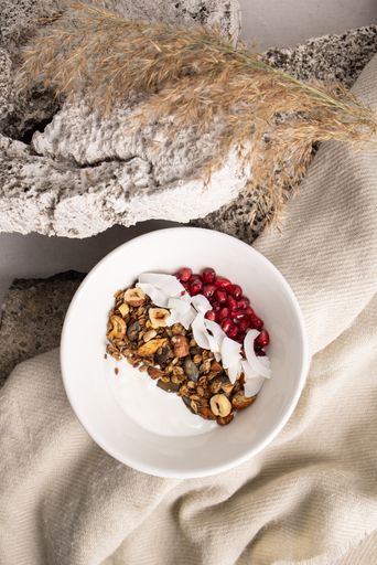 A Top view of a  plate of granola with fruits and white yogurt, breakfast idea