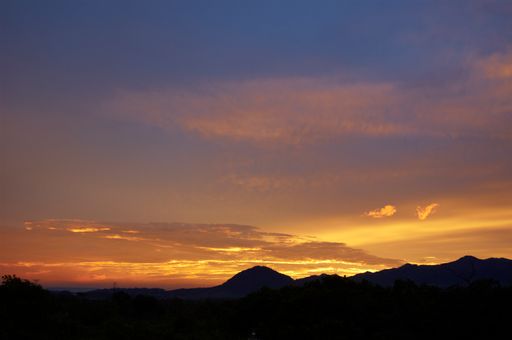 A scenic sunset view with the dramatic sky over the mountains