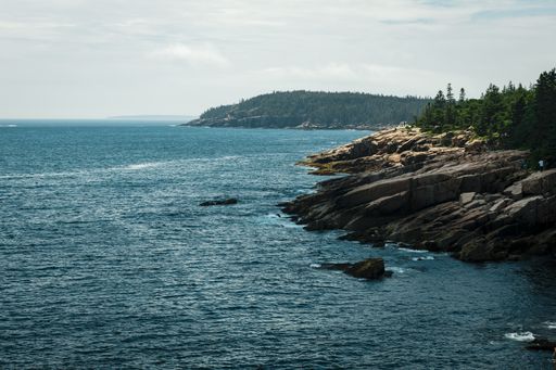 A beautiful view of a rocky shore under the blue sky