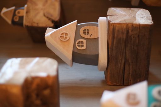 A vertical shot of a small wooden house with beautiful design as a gift