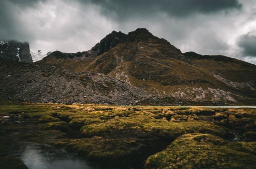 A mesmerizing view of a mountain under cloudy sky in Peru