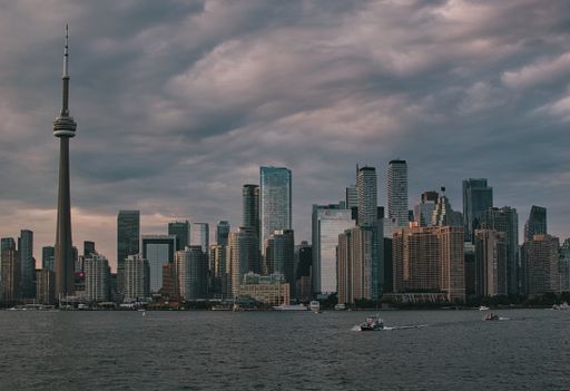 A urban panorama with high-rise buildings and TV tower with cloudy sky on the background