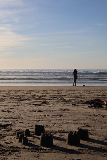 A vertical shot of people walking and resting in Baja California beach, Mexico