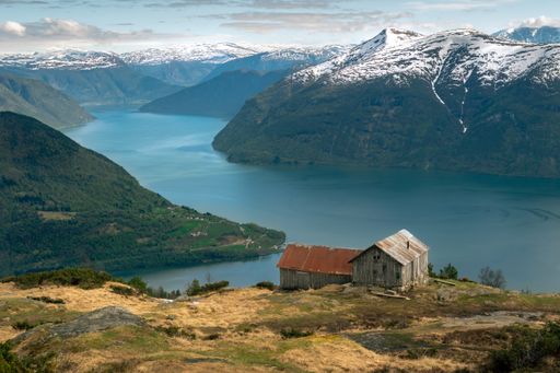An aerial view of the river flowing between the Mulden Mountains in Norway