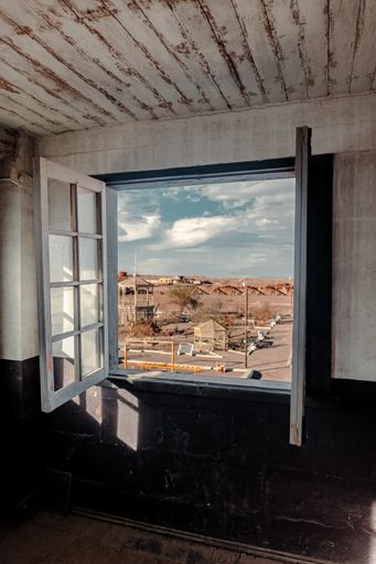 A vertical view of a desert seen from an old window of an abandoned house in Chile