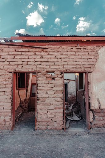 A vertical shot of an old house structure on abandoned land