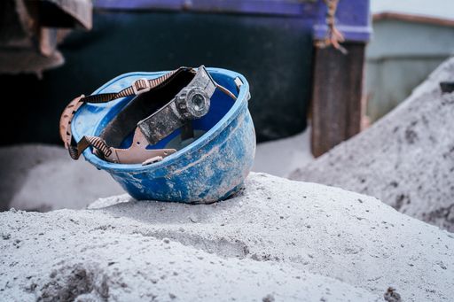A closeup shot of a dirty blue construction helmet
