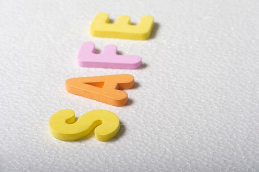 A closeup shot of colorful tile letters spelling safe on a white background