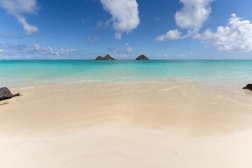 A view of the twin islands of Na Mokulua from Lanikai Beach in Kailua, Hawaii, USA