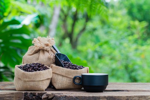 The bags with coffee beans and a cup