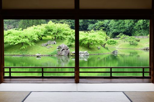 A view of a beautiful park with lake from a big window