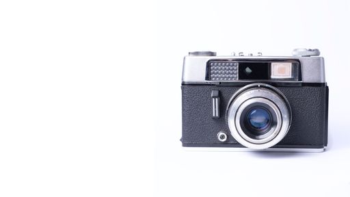 An old vintage camera isolated on a white background