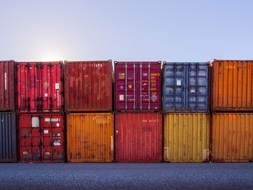 Two rows of multicoloured shipping containers stacked on top of each other