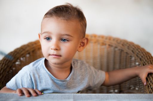 A closeup shot of a Caucasian child looking into somewhere