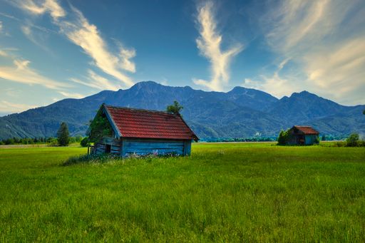A beautiful shot of a lonely hut in a mountain landscape under the cloudy skies