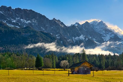 A beautiful shot of a lonely hut in a mountain landscape under the cloudy skies