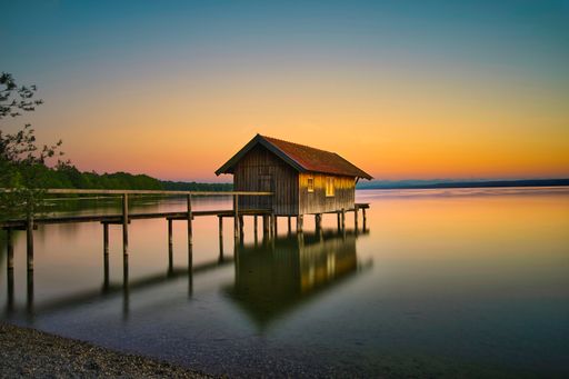 A beautiful shot of a lonely fishing lodge on a lake in Bavaria, 
Germany
