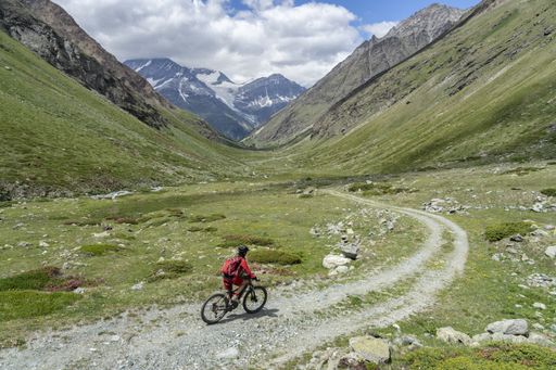 active senior woman, riding her electric mountainbike below the famous Matterhorn in Zermatt, Wallis,Switzerland