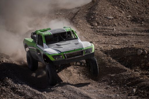 A closeup of a green off-road race car in the desert in Las Vegas, NV, USA