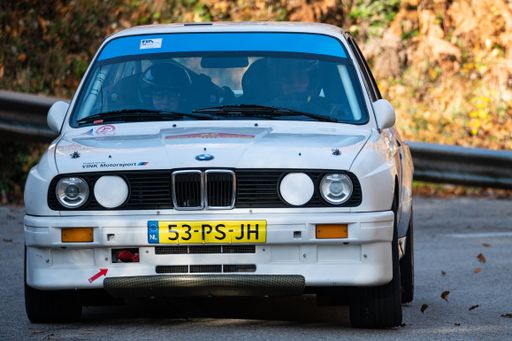 A white BMW E30 M3 rally car driving during the 69th Rally Costa Brava competition