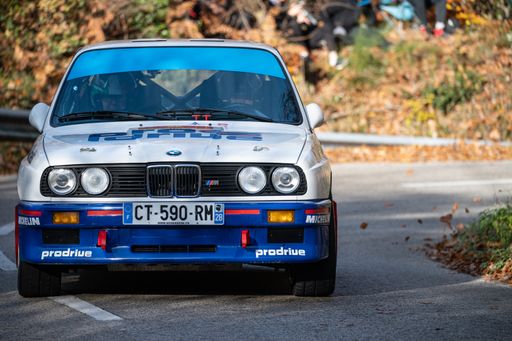 A blue BMW E30 M3 rally car driving during the 69th Rally Costa Brava competition