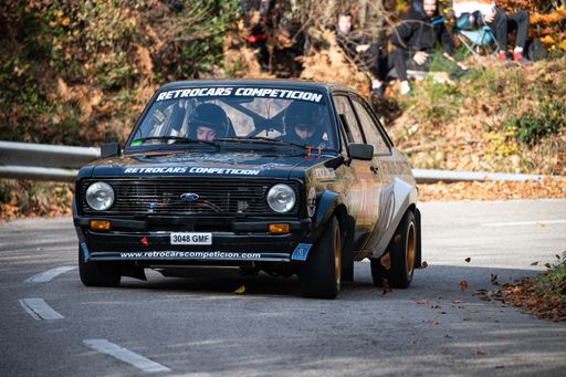 A black Ford Escort RS2000 MKII rally car driving during the 69th Rally Costa Brava competition