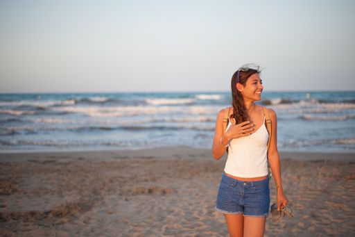 A closeup shot of a Caucasian woman walking near the sea