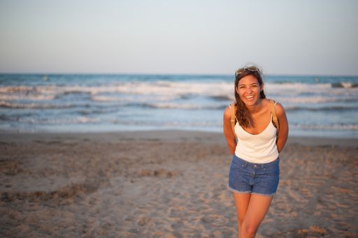 A closeup shot of a Caucasian woman walking near the sea