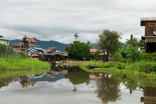 Floating houses and buildings built on the water or riverbank of Inle Lake, Myanmar, Burma, SE Asia, with high level of water during monsoon season.