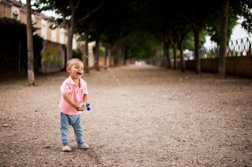 A happy toddler with a bottle of water