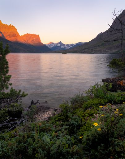 A vertical shot of a lake with mountains in the background