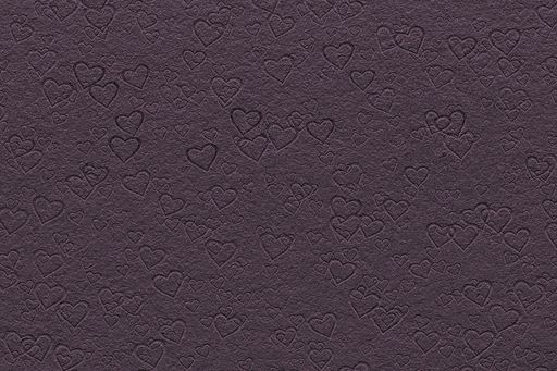A closeup shot of several hearts drawn on a dark surface
