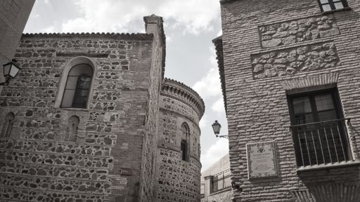 A closeup of a brick building and a semi-circular curved wall