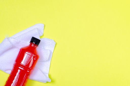 A top view of a red Electric Energy Drink bottles isolated on a yellow background with a copy space