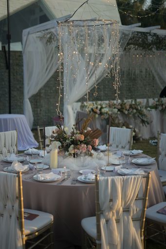 A beautiful table setting decorated with flowers and candles for a wedding reception