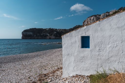 The white building on the shore of the sea in Spain