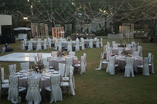 A beautiful table setting with floral decorations and candles for a wedding reception evening