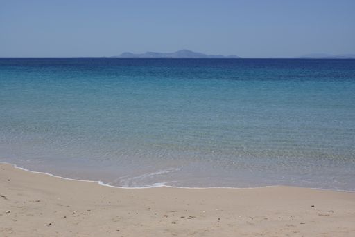 A view of the Aegean sea at a quiet, beautiful beach on the charming Greek island of Donoussa. Crystal clear blue waters  a peaceful bay.