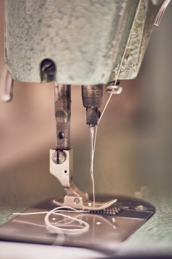 A closeup vertical shot of a working sewing machine