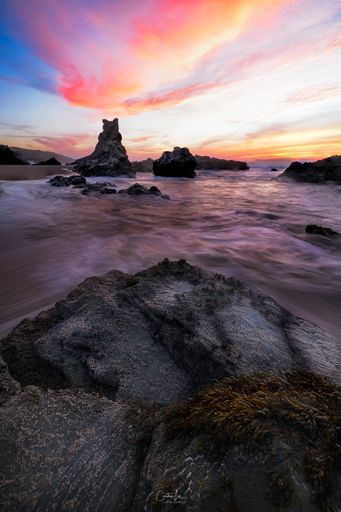 A vertical shot of scenic sunset at the beach in Alentejo (Porto Covo, Portugal)