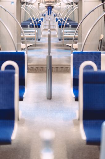Several blue seats in the bus during daytime in Munich, Germany