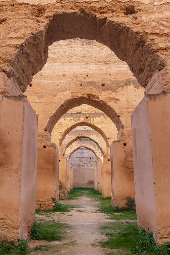 A low angle shot of antique stone arches row