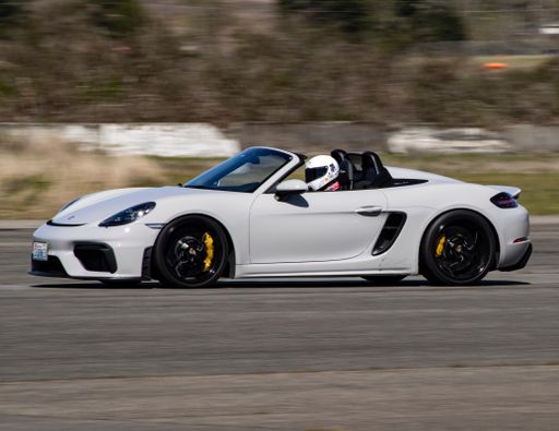 A White Porsche car racing on a runway in Washington