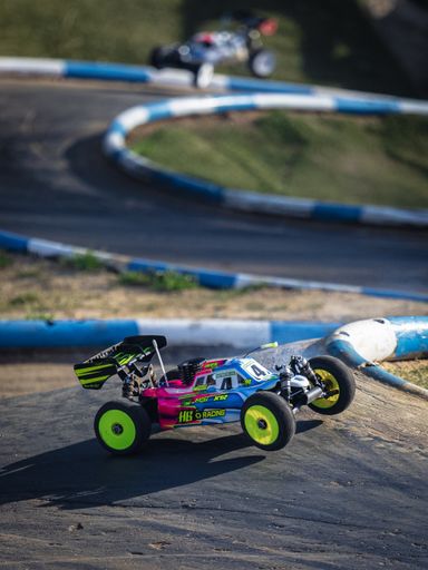 A colorful radio-controlled buggy on the track, France